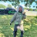 Image showcasing our tech Bryan removing a ground hornet nest, showing his care and attention to detail, keeping your yard happy and sting-free!