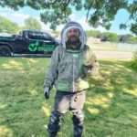 Image showcasing our tech Bryan removing a ground yellow jacket nest, showing his care and attention to detail, keeping your yard happy and sting-free!